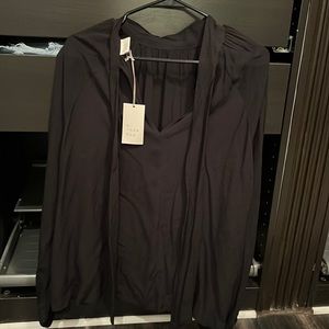 Never worn size large black shirt with tie in back